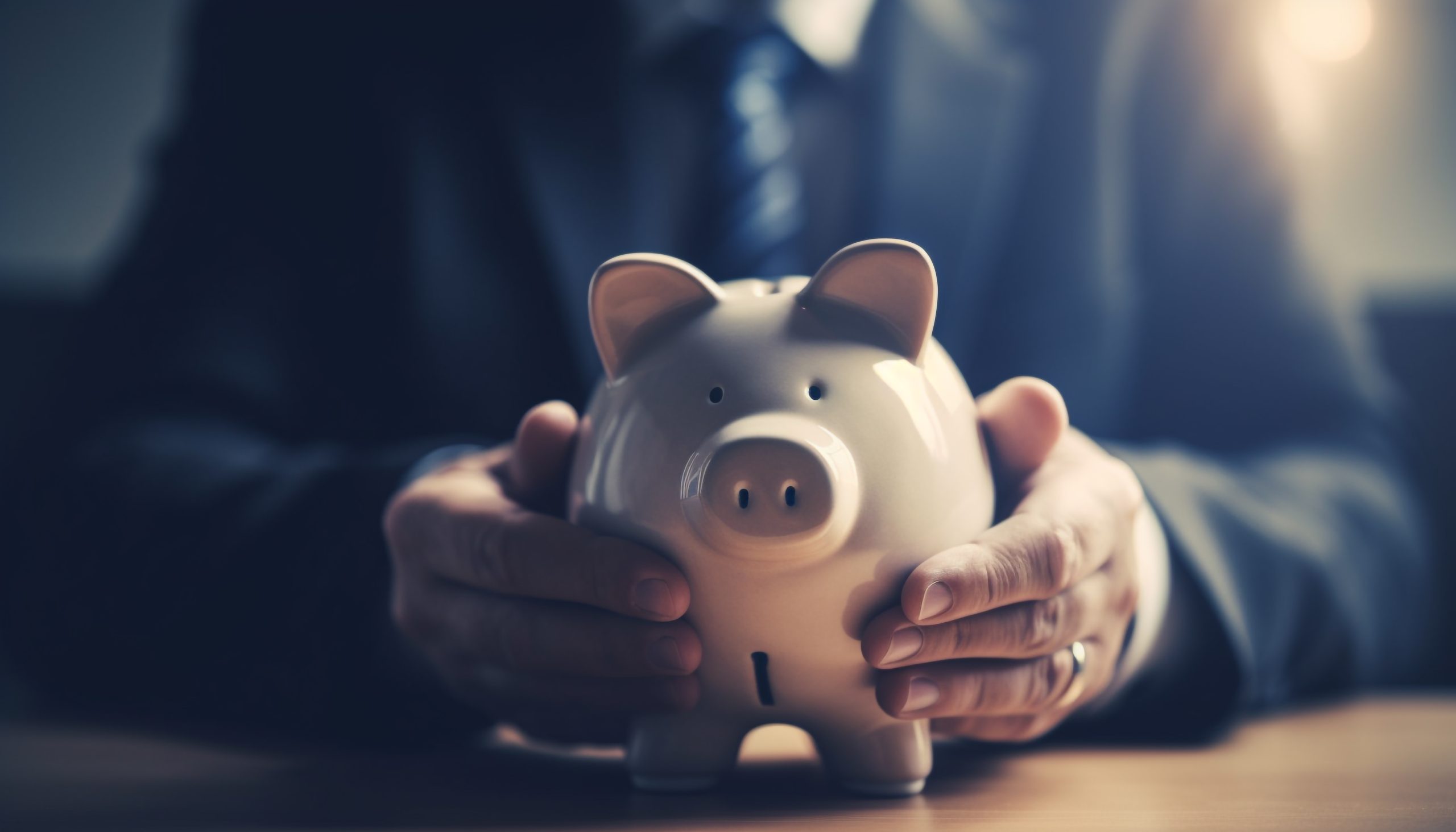 Caucasian businessman holding piggy bank for savings generated by AI